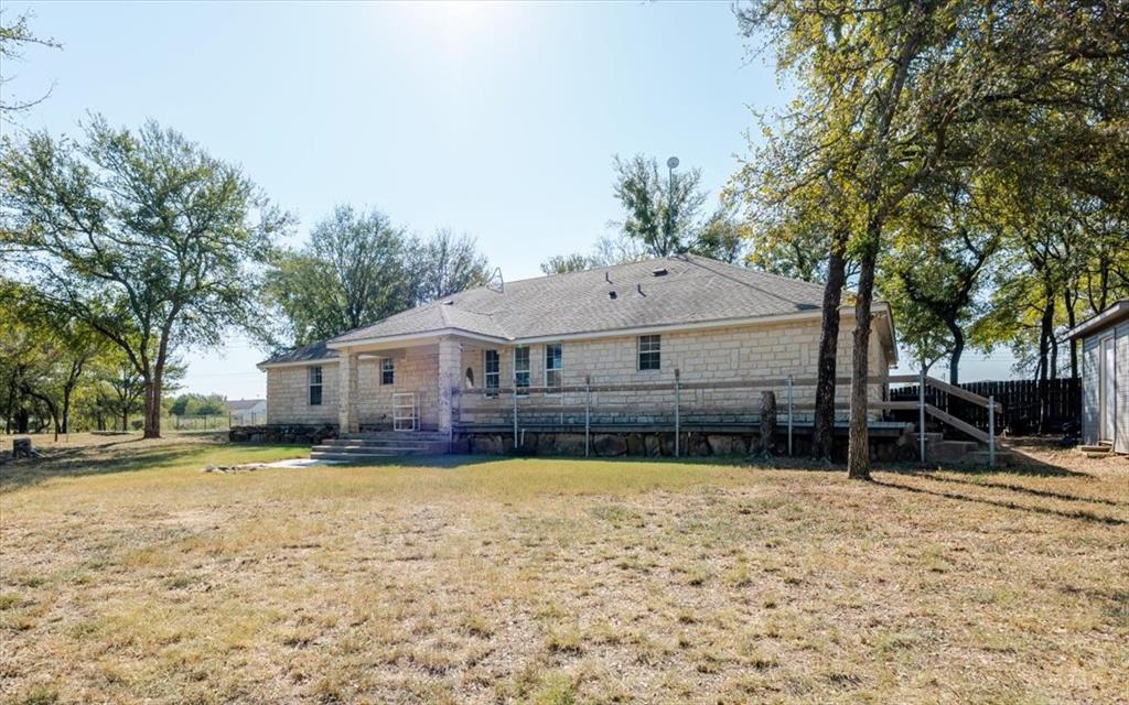 2350 Grindstone Road Millsap, TX 76066 - Photo 7 of 33 a front view of a house with a yard and garage