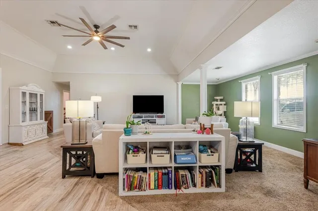 a room with a flat screen tv and a large window