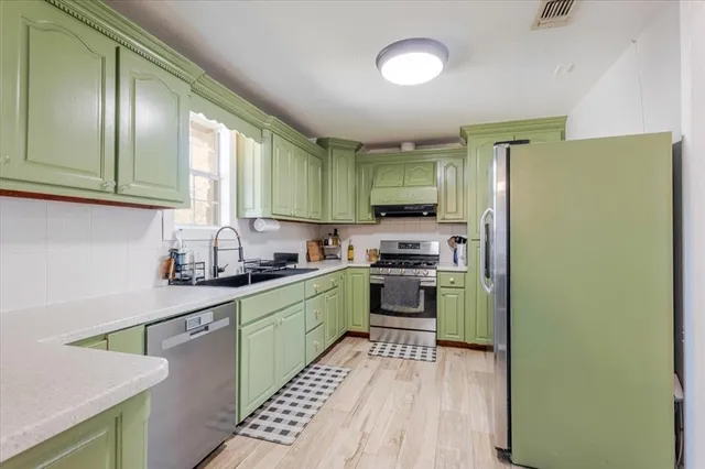 a kitchen with a refrigerator and a sink