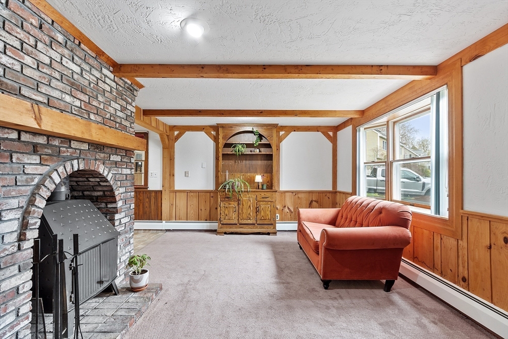 40 Elizabeth Road Billerica, MA 01821 - Photo 11 of 42 a living room with furniture a fireplace and large windows