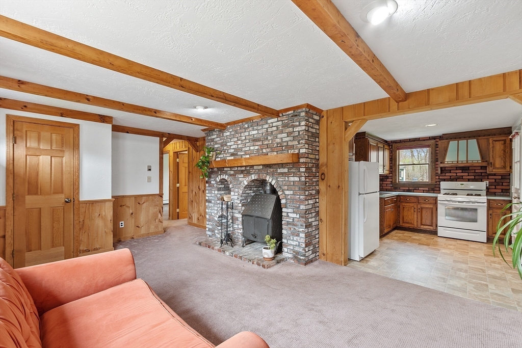 40 Elizabeth Road Billerica, MA 01821 - Photo 12 of 42 a living room with furniture and a fireplace