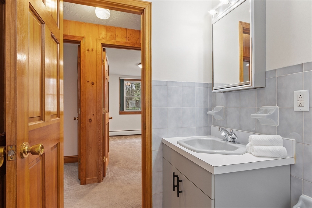 40 Elizabeth Road Billerica, MA 01821 - Photo 31 of 42 a bathroom with a sink and a mirror