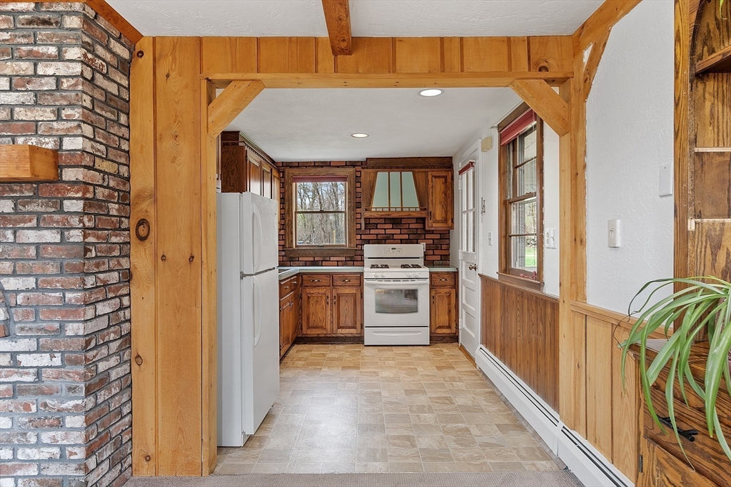 40 Elizabeth Road Billerica, MA 01821 - Photo 5 of 42 a view of a kitchen with a sink and dishwasher a stove top oven with wooden floor