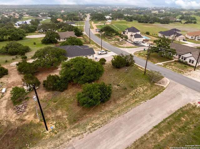 an aerial view of a house with a lake view