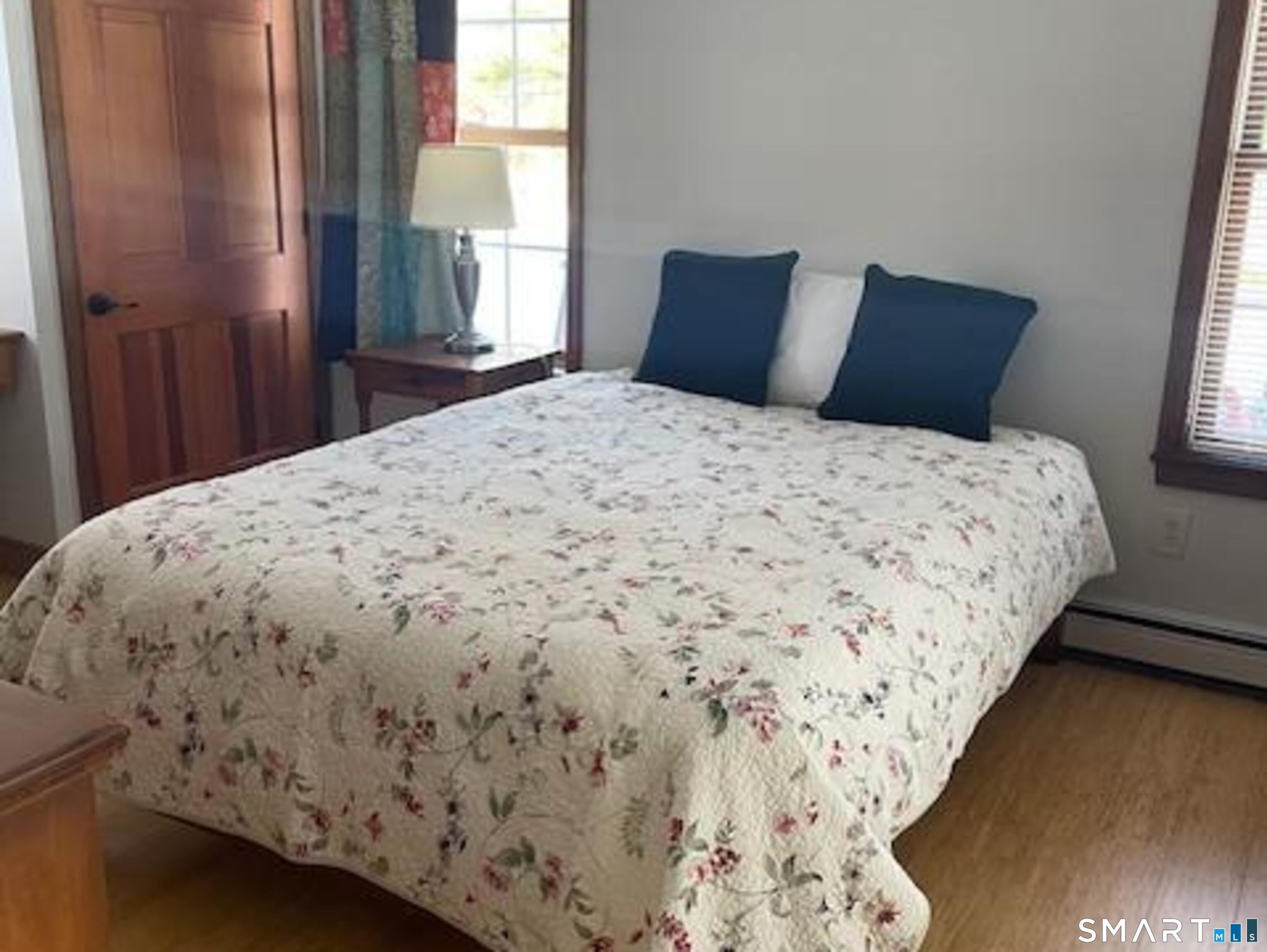 415 Kent Hollow Road Kent, CT 06785 - Photo 6 of 10 a bedroom with a bed and wooden floor