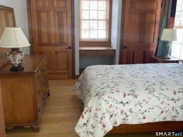 a bedroom with a bed and a window