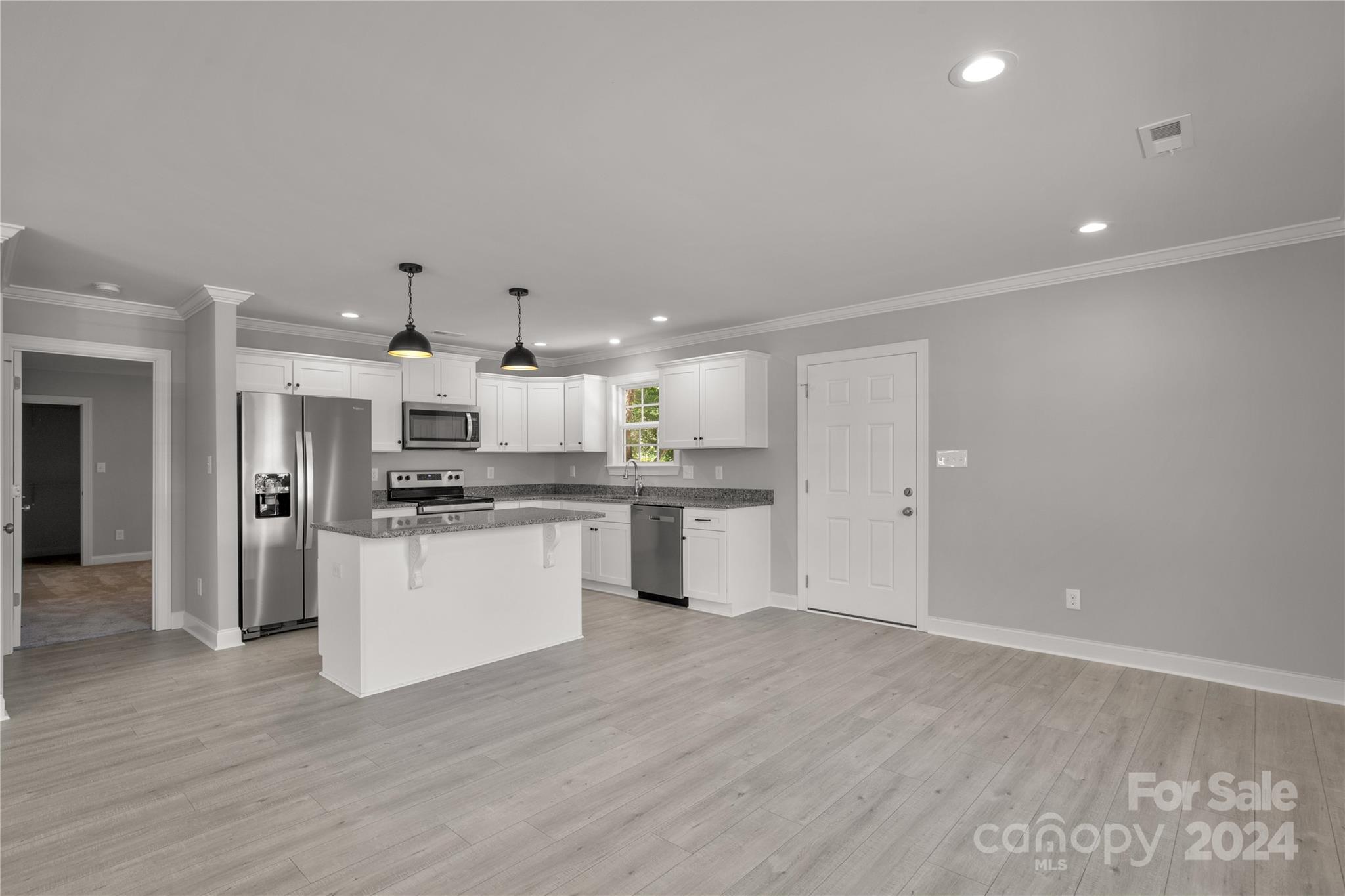 1780 Airport Road Lancaster, SC 29720 - Photo 11 of 26 a kitchen with stainless steel appliances kitchen island wooden cabinets and granite counter tops