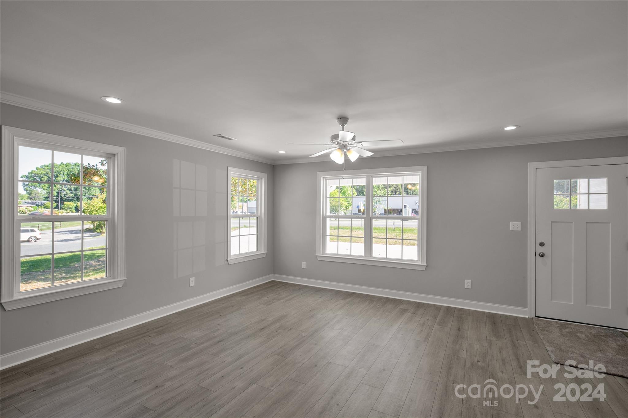 1780 Airport Road Lancaster, SC 29720 - Photo 14 of 26 a view of an empty room with wooden floor and a window