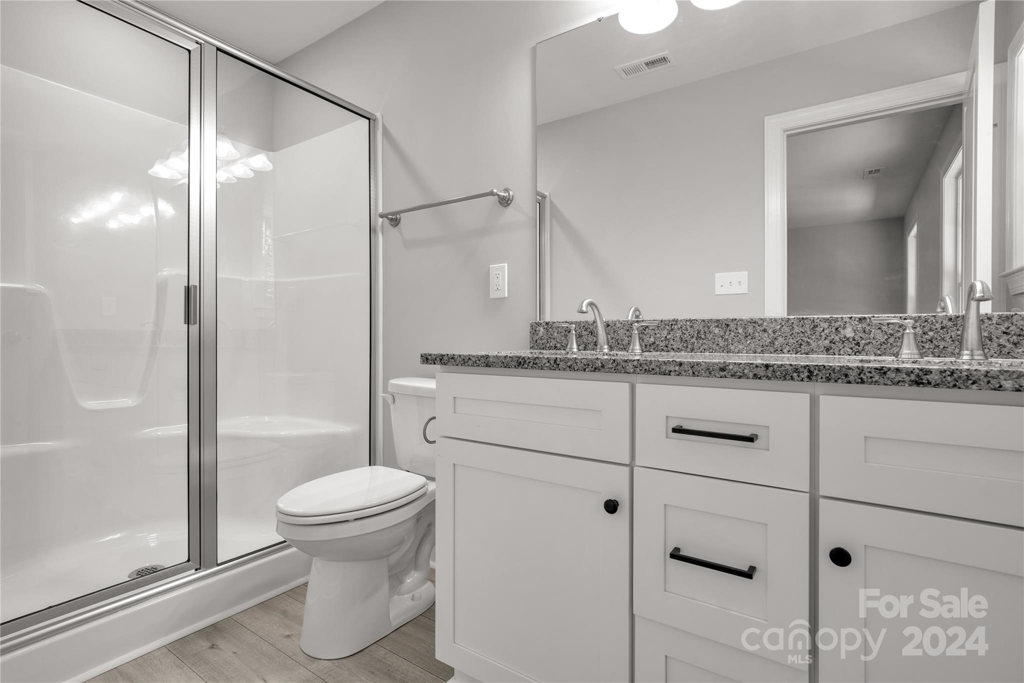 1780 Airport Road Lancaster, SC 29720 - Photo 17 of 26 a bathroom with a granite countertop sink toilet and shower