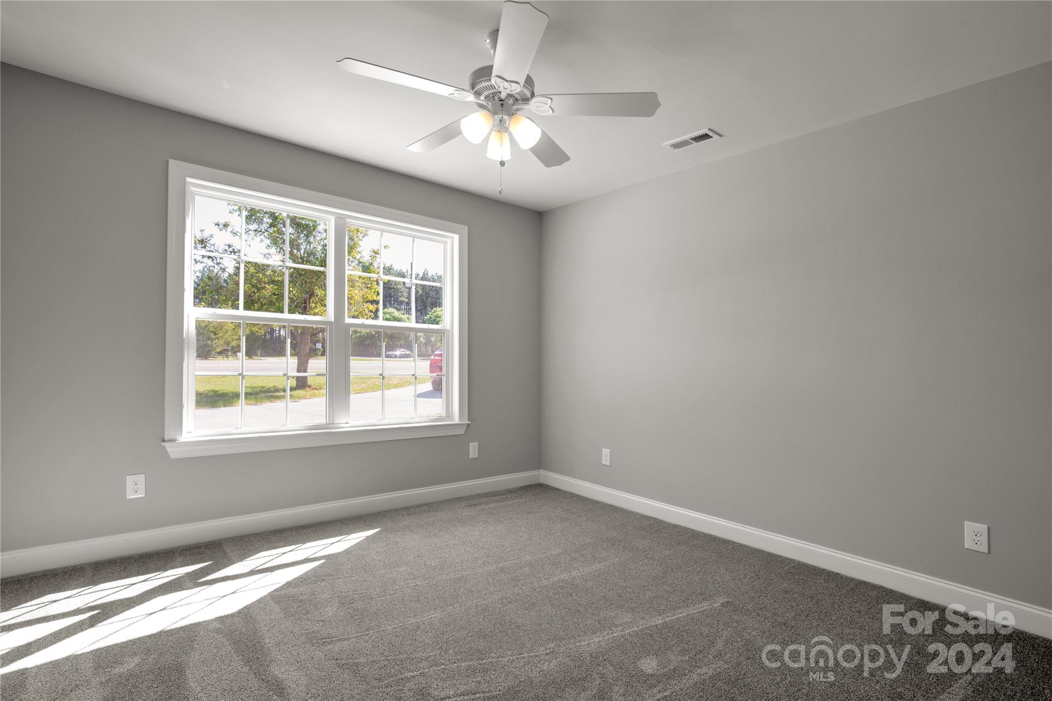 1780 Airport Road Lancaster, SC 29720 - Photo 18 of 26 en empty room with windows and ceiling fan