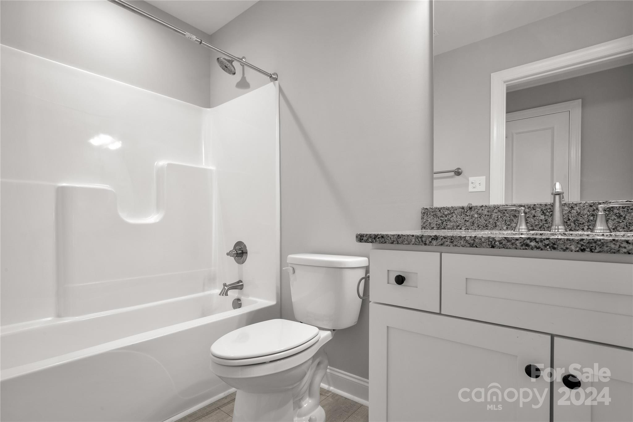 1780 Airport Road Lancaster, SC 29720 - Photo 23 of 26 a bathroom with a granite countertop toilet a sink and a bathtub