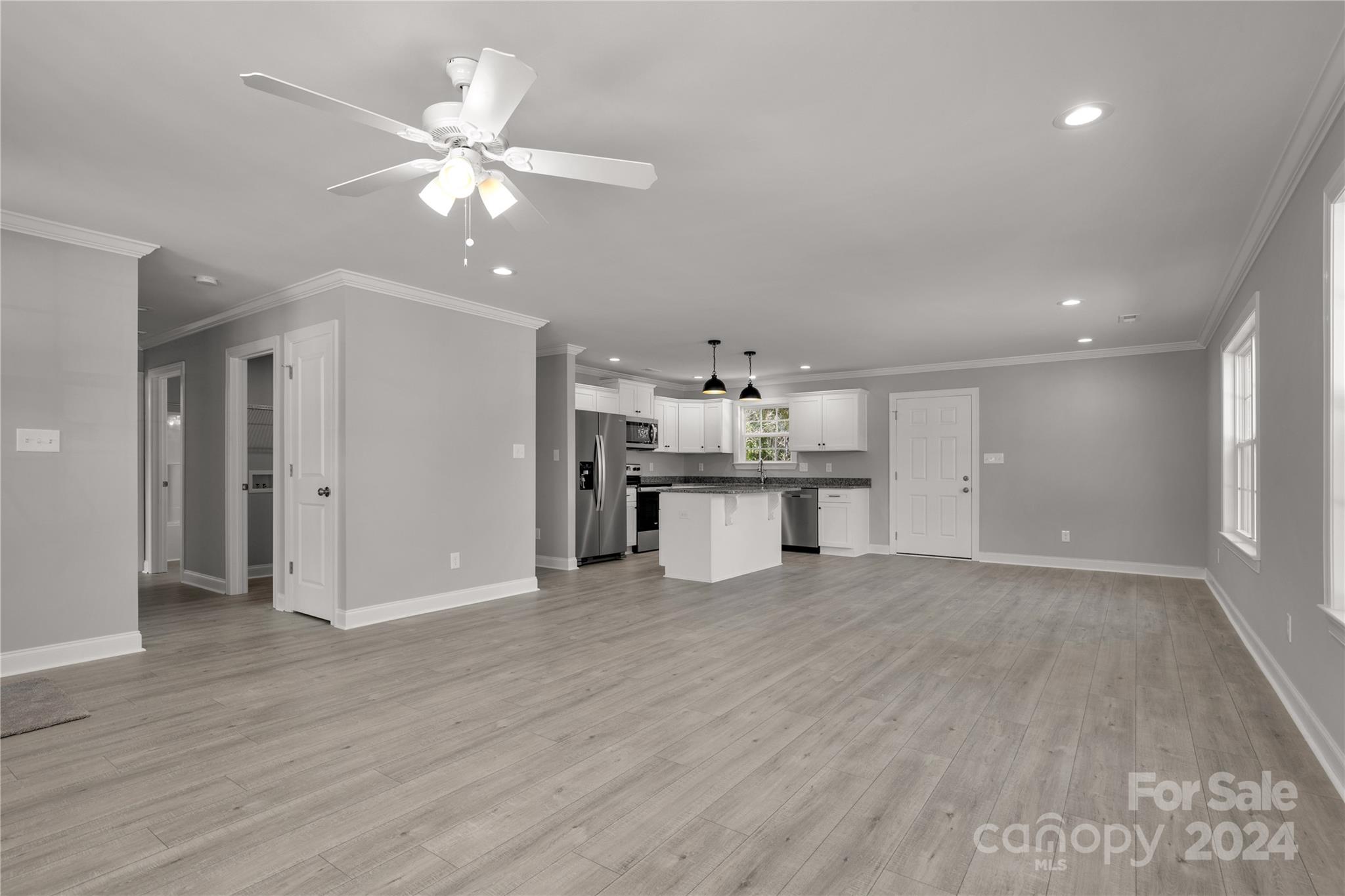 1780 Airport Road Lancaster, SC 29720 - Photo 9 of 26 a view of an empty room with wooden floor and a ceiling fan