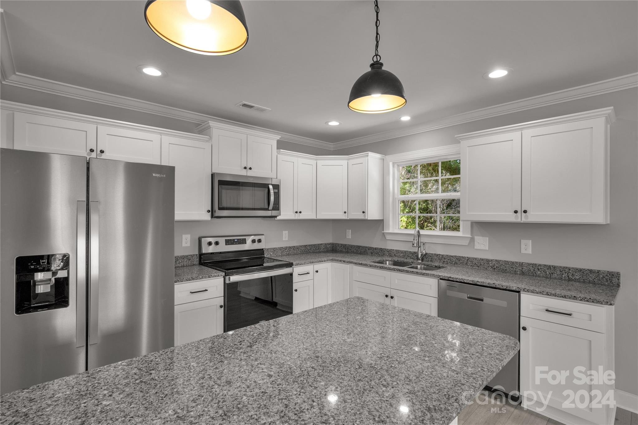 1780 Airport Road Lancaster, SC 29720 - Photo 10 of 26 a kitchen with granite countertop stainless steel appliances a stove sink microwave and refrigerator