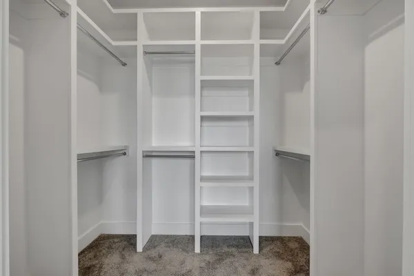 a view of a hallway with wooden floor and entryway
