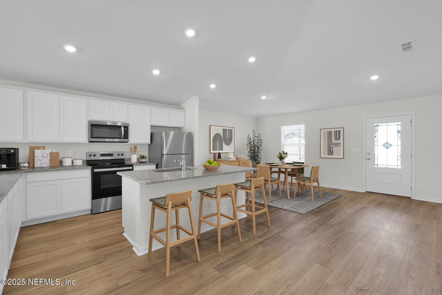 37282 Whisper Way Hilliard, FL 32046 - Photo 3 of 11 a kitchen with a dining table chairs wooden floor appliances and cabinets