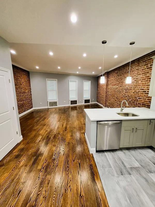 a large kitchen with a lot of counter space and a wooden floors
