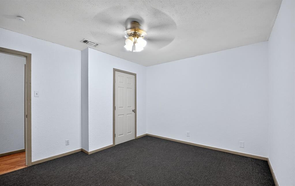 604 Fegan Street Weatherford, TX 76086 - Photo 17 of 36 an empty room with a chandelier fan