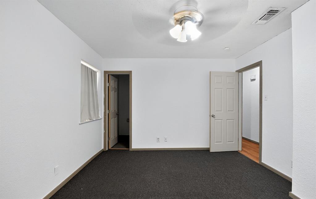 604 Fegan Street Weatherford, TX 76086 - Photo 21 of 36 an empty room with a chandelier fan and closet