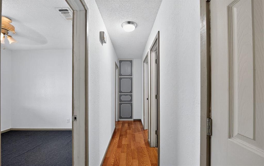 604 Fegan Street Weatherford, TX 76086 - Photo 25 of 36 a view of a hallway with a livingroom and a bathroom