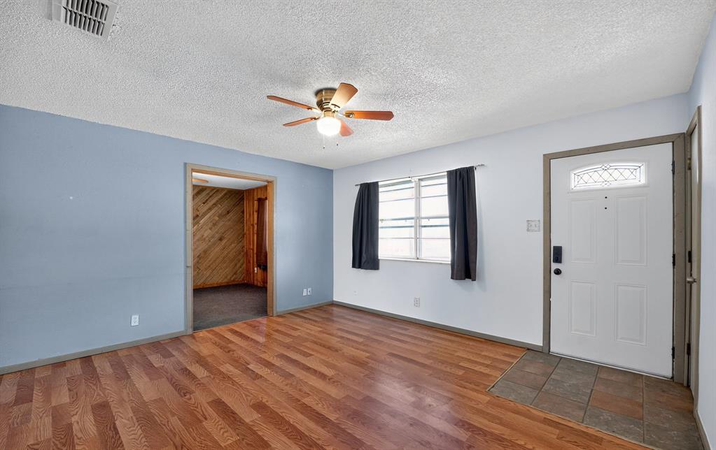 604 Fegan Street Weatherford, TX 76086 - Photo 5 of 36 wooden floor in an empty room with a window