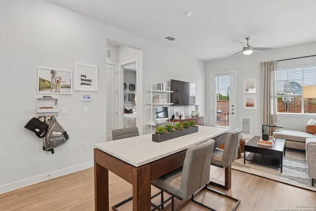 a kitchen with a table chairs refrigerator and microwave
