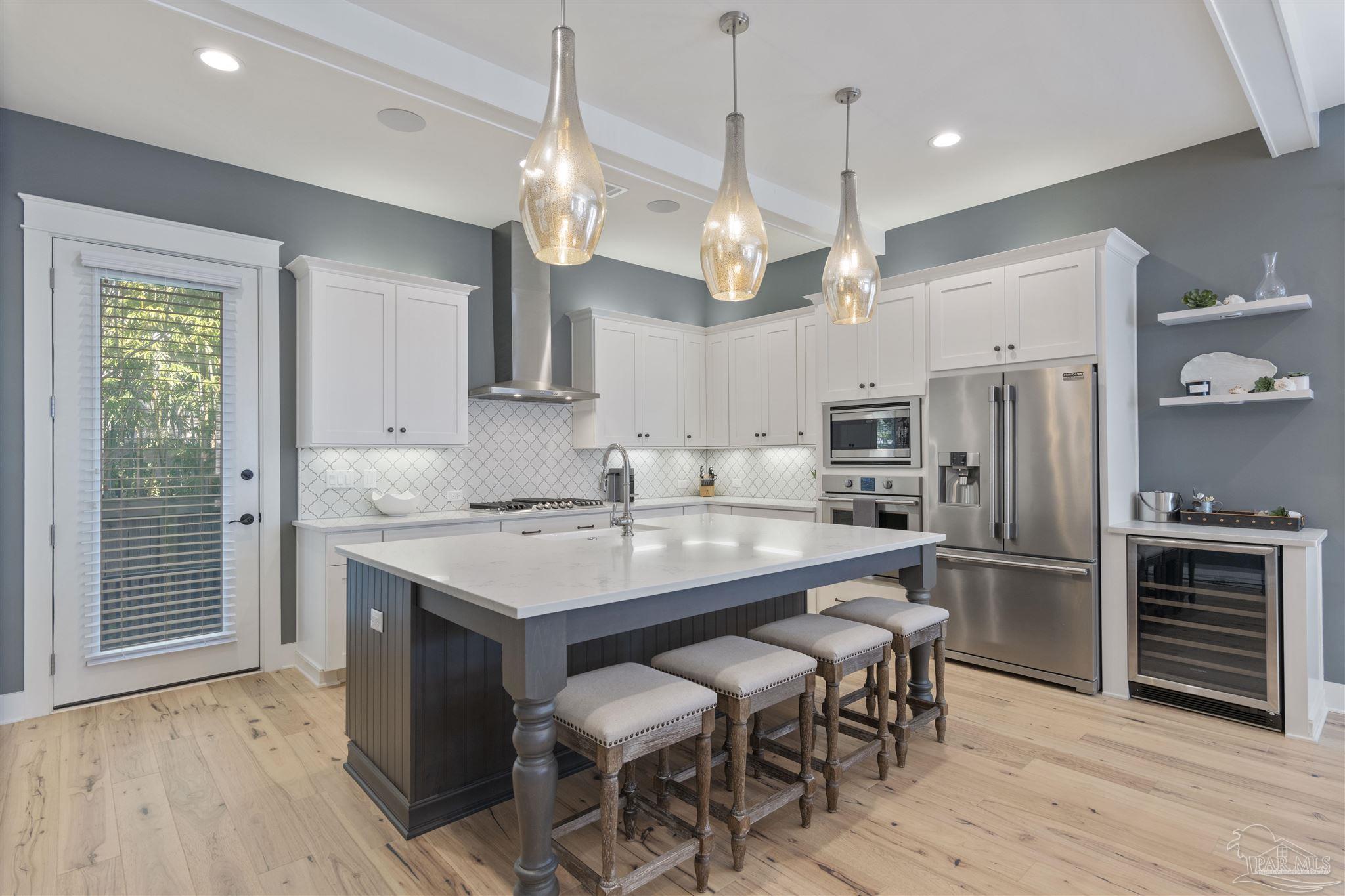 321 Ridgewalk Circle Santa Rosa Beach, FL 32459 - Photo 13 of 42 a kitchen with kitchen island a dining table chairs stainless steel appliances and cabinets