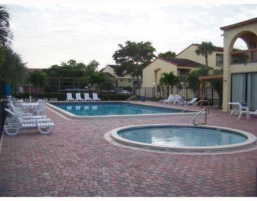 4091 Sierra Terrace, Unit 4091 Sunrise, FL 33351 - Photo 19 of 24 a view of outdoor space yard swimming pool and patio