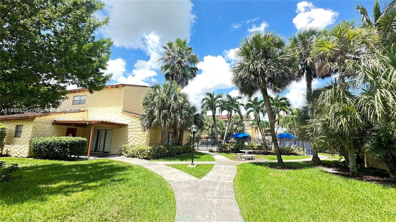 4091 Sierra Terrace, Unit 4091 Sunrise, FL 33351 - Photo 3 of 24 a view of a house with swimming pool and a large tree