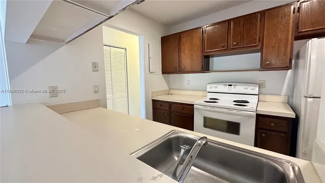 a kitchen with a stove a sink and a refrigerator
