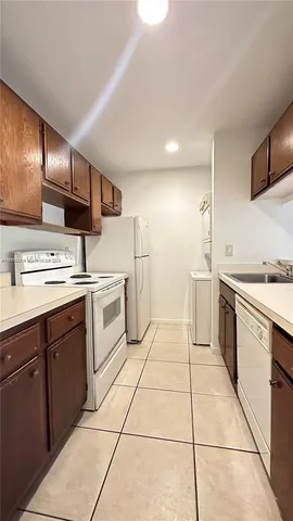 a kitchen with a stove top oven sink and cabinets