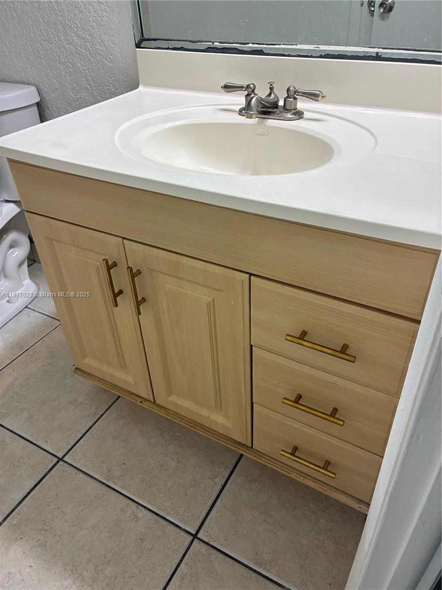 4091 Sierra Terrace, Unit 4091 Sunrise, FL 33351 - Photo 9 of 24 a bathroom with a sink and a mirror
