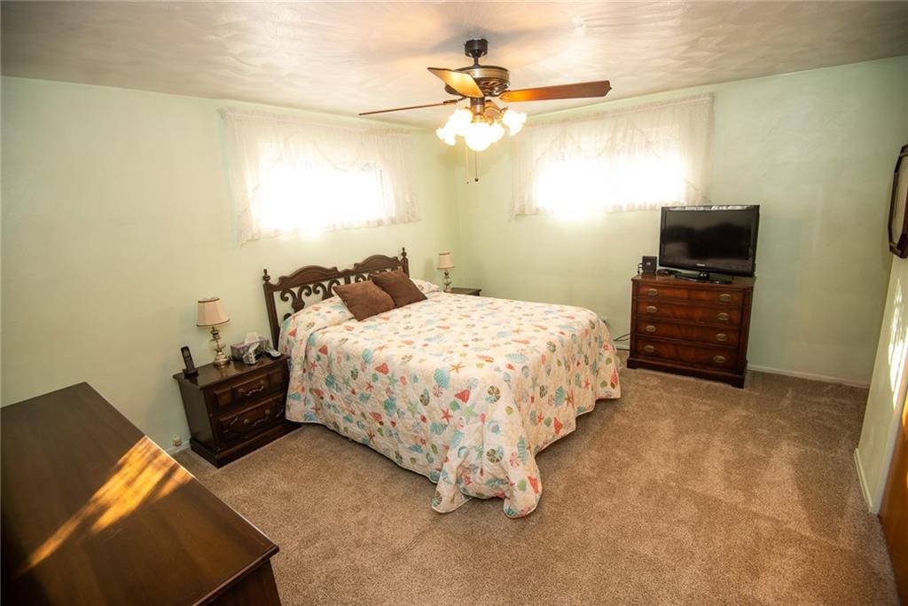 47 Grubbs Road Cheswick, PA 15024 - Photo 11 of 22 a bedroom with a bed and a chandelier