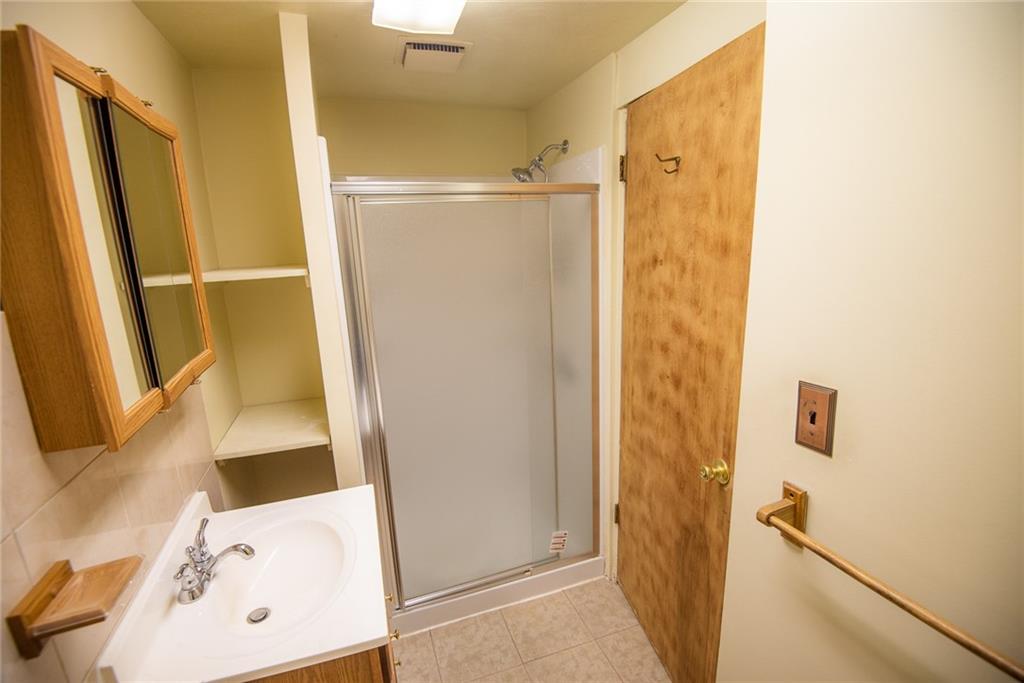 47 Grubbs Road Cheswick, PA 15024 - Photo 17 of 22 a bathroom with a sink a mirror and a shower