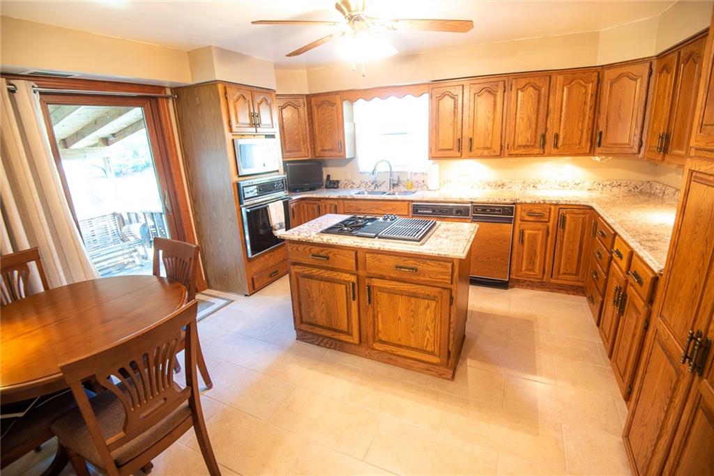 47 Grubbs Road Cheswick, PA 15024 - Photo 6 of 22 a kitchen that has a sink a table and chairs in it
