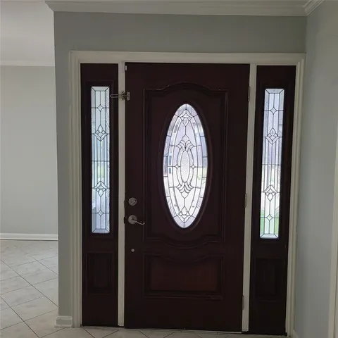 an empty room with windows and fireplace