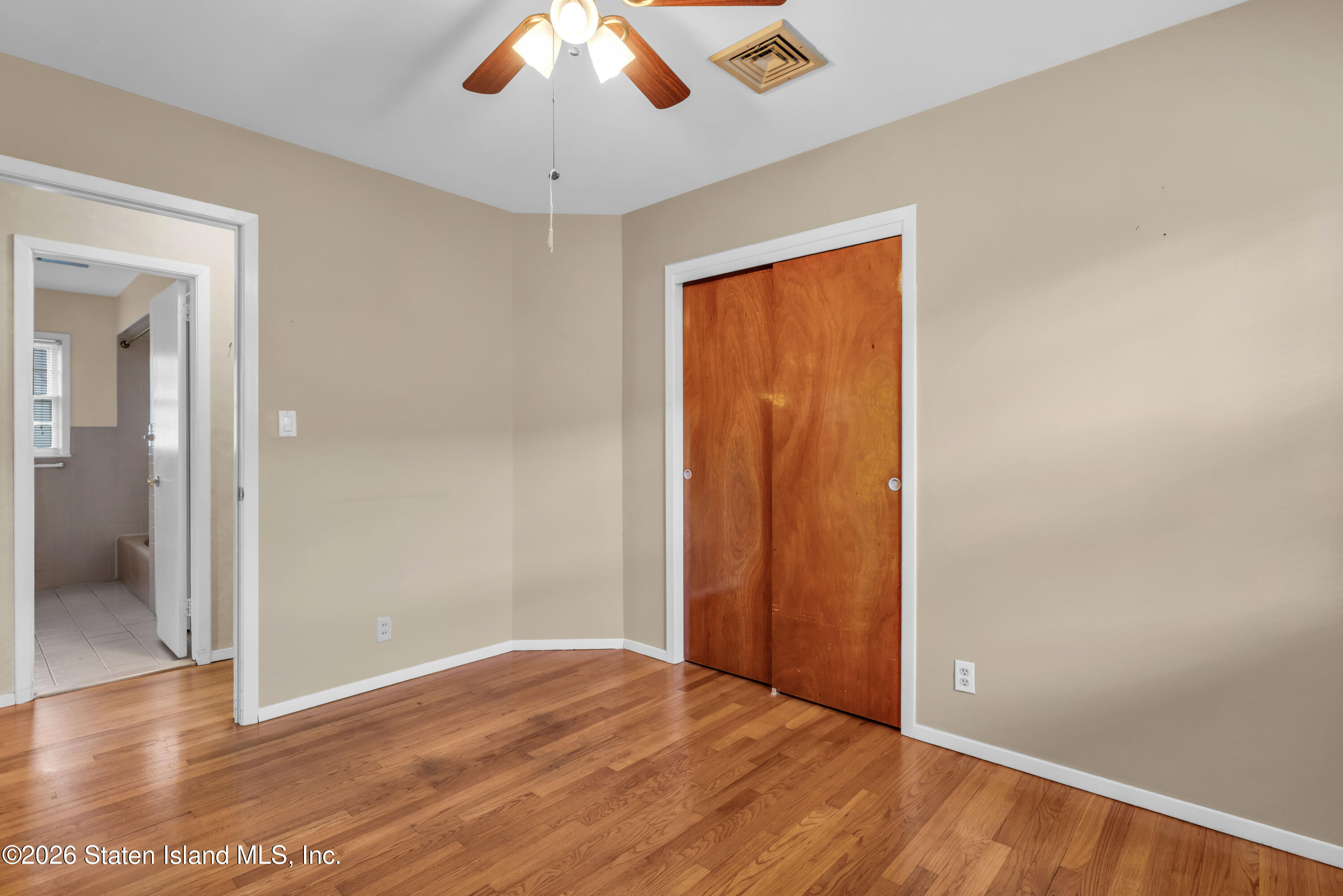 203 Wolverine Street Staten Island, NY 10306 - Photo 14 of 26 a view of an empty room with wooden floor