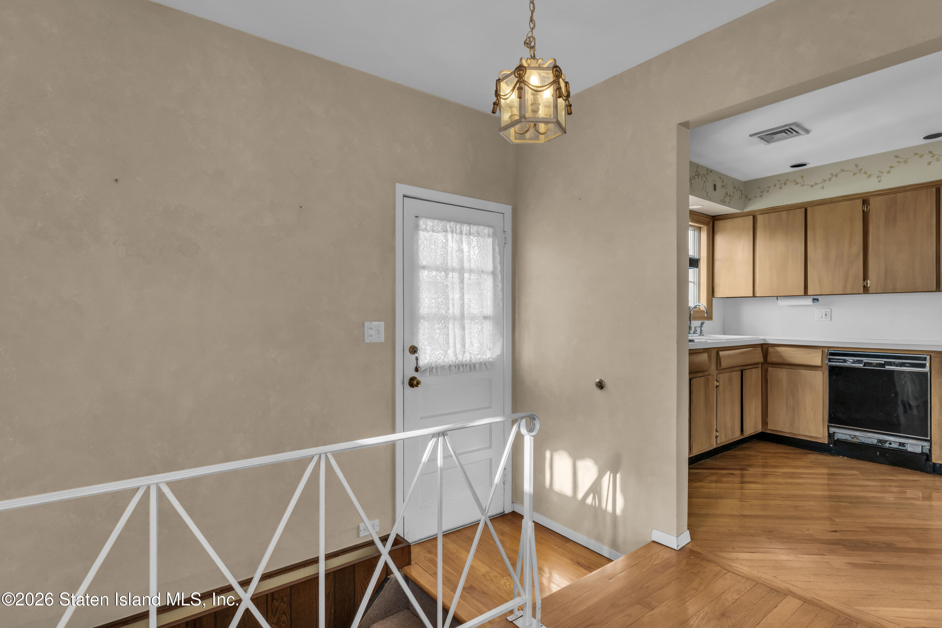 203 Wolverine Street Staten Island, NY 10306 - Photo 17 of 26 a view of a kitchen with a sink wooden cabinet and stainless steel appliances
