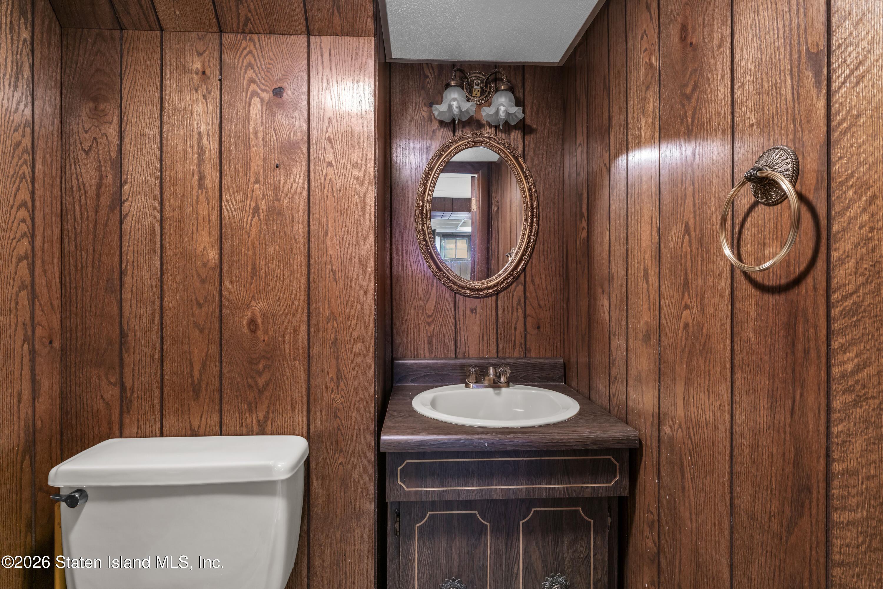 203 Wolverine Street Staten Island, NY 10306 - Photo 21 of 26 a bathroom with a toilet a sink and mirror