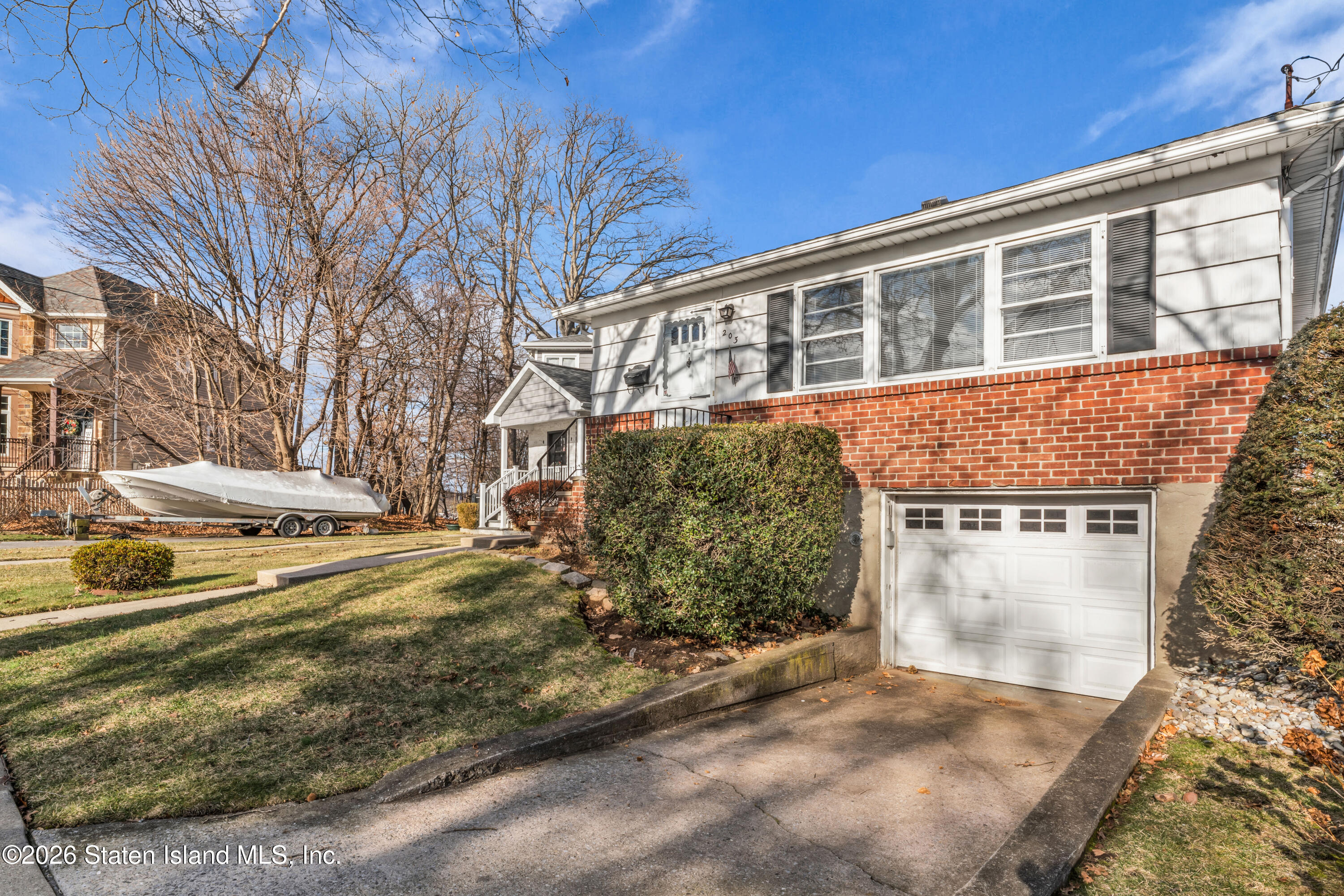 203 Wolverine Street Staten Island, NY 10306 - Photo 26 of 26 a view of a house with car parked on road