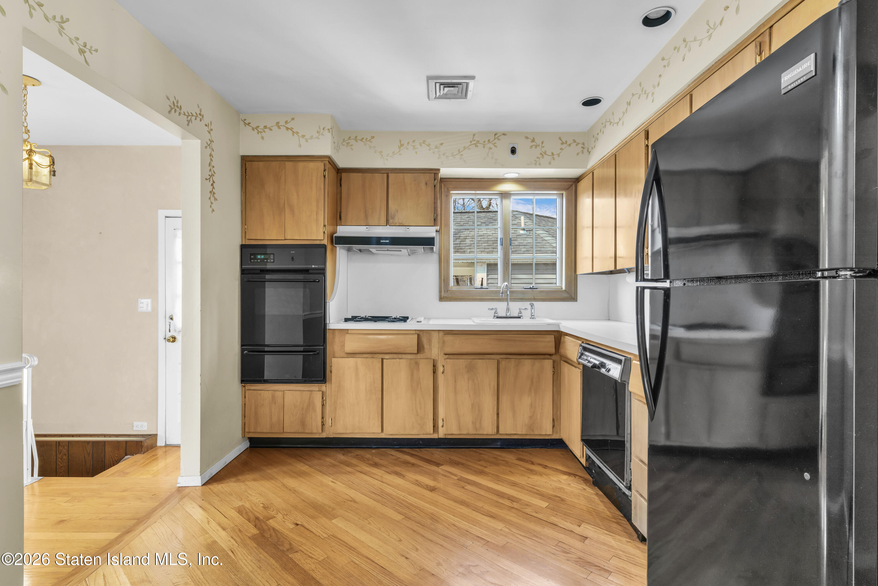 203 Wolverine Street Staten Island, NY 10306 - Photo 4 of 26 a kitchen with white cabinets and refrigerator