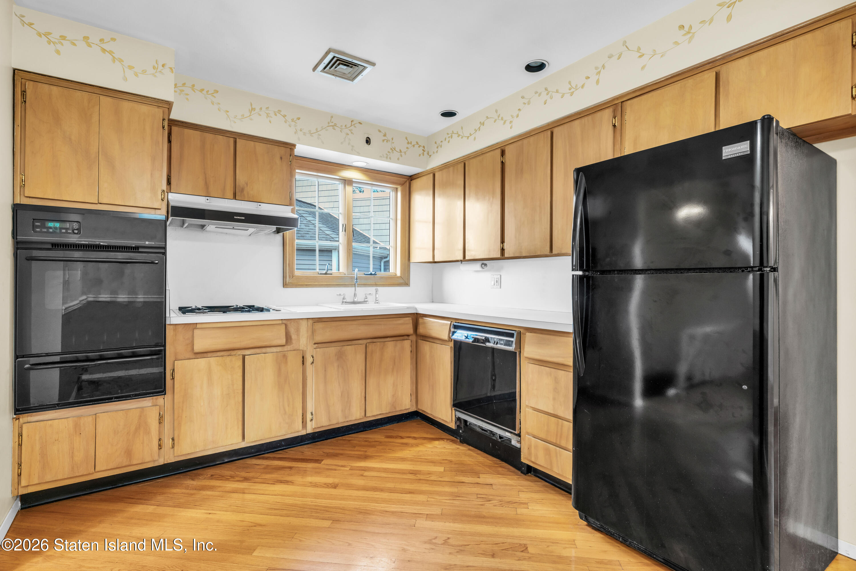203 Wolverine Street Staten Island, NY 10306 - Photo 5 of 26 a kitchen with a refrigerator and a sink