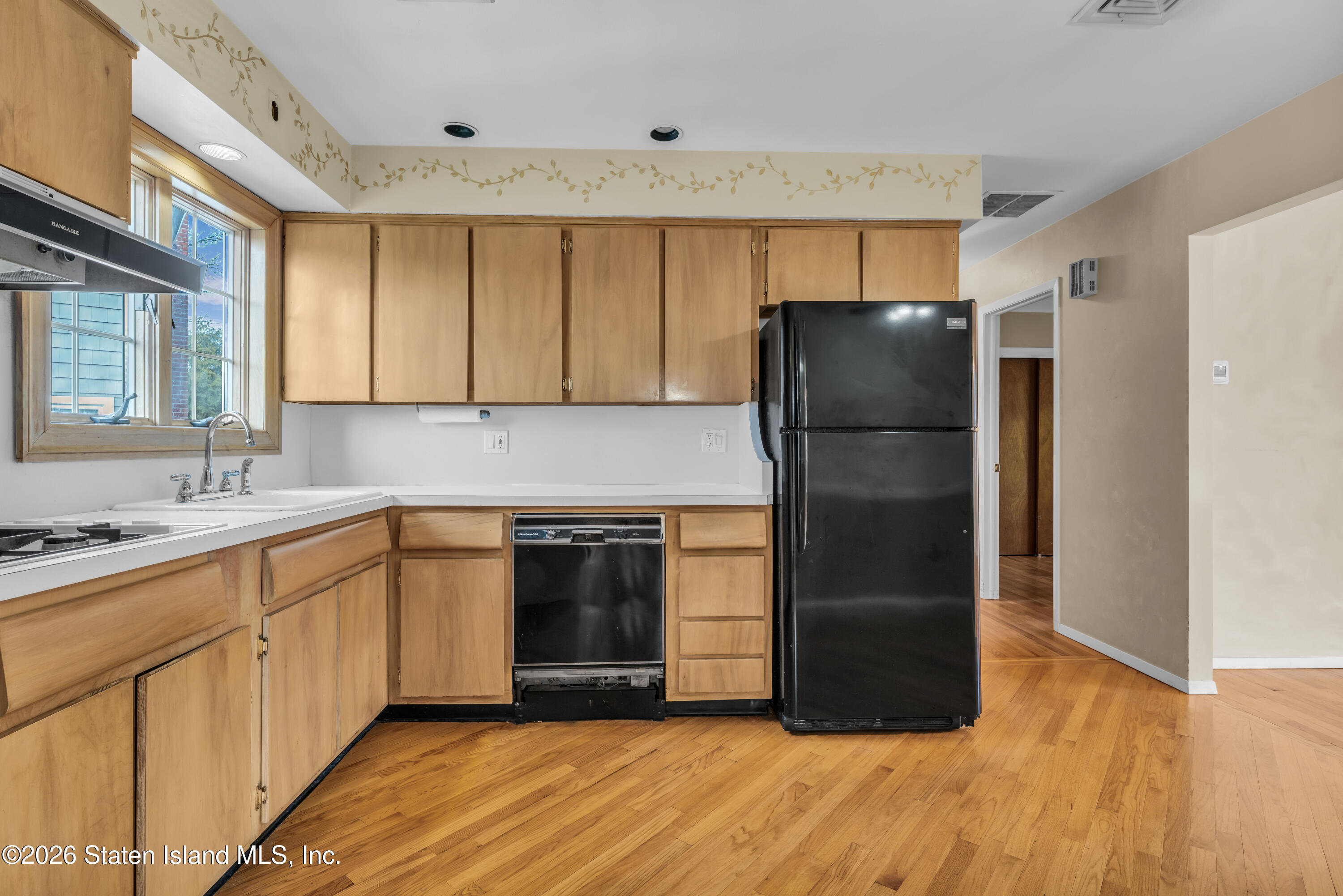 203 Wolverine Street Staten Island, NY 10306 - Photo 6 of 26 a kitchen with a refrigerator and a sink