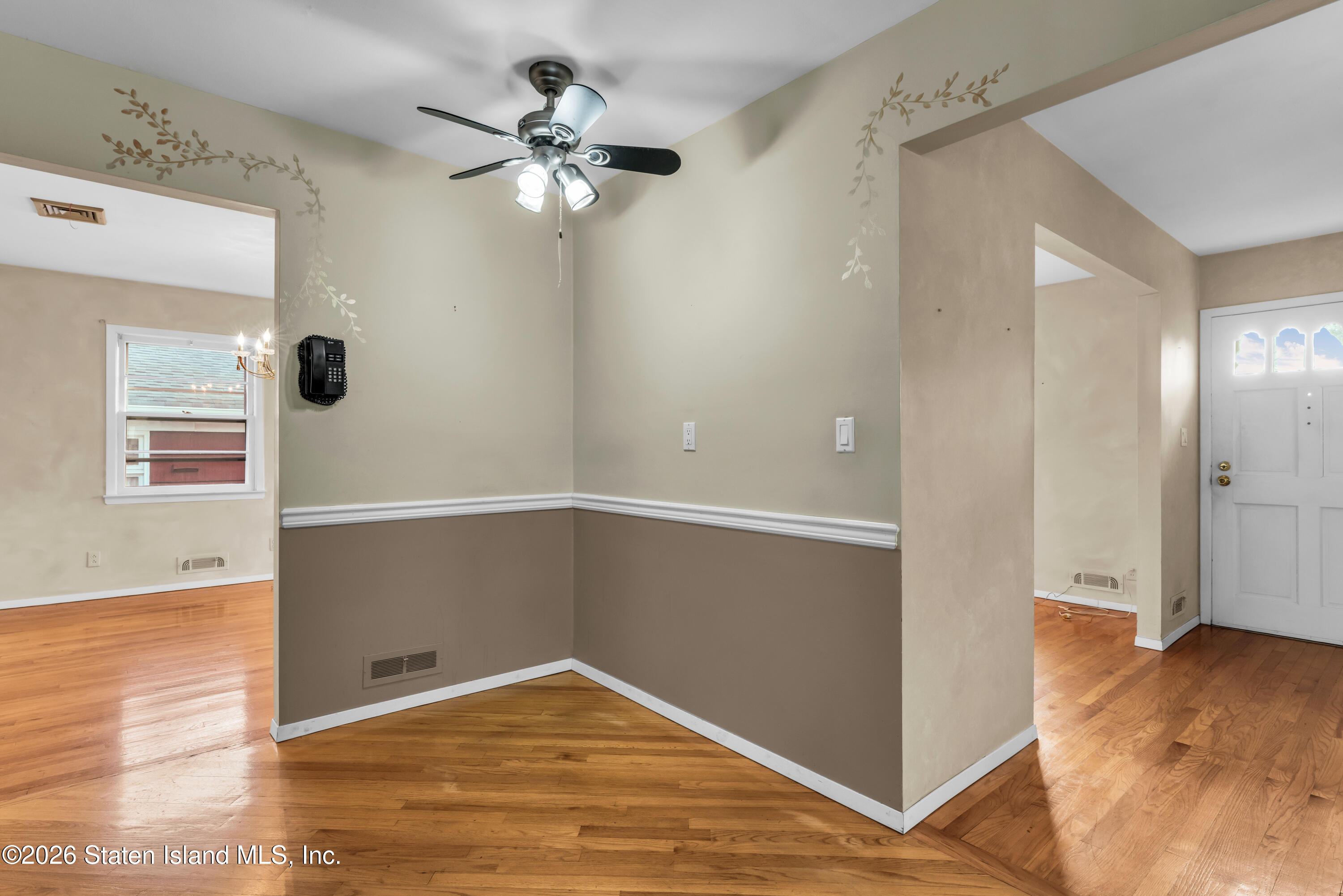 203 Wolverine Street Staten Island, NY 10306 - Photo 7 of 26 a view of an empty room with wooden floor