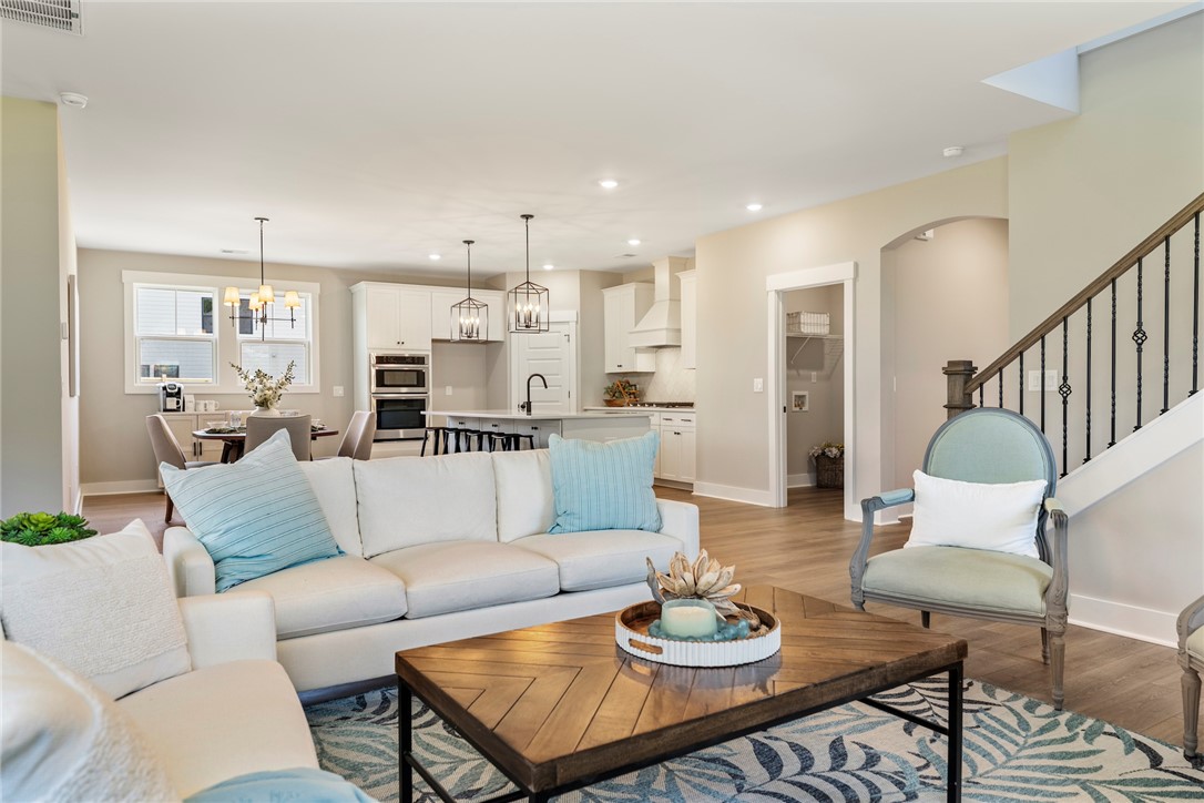 133 Osprey Landing Central, SC 29630 - Photo 9 of 34 This open concept living space features a modern kitchen, dining area, and easy access to a staircase.