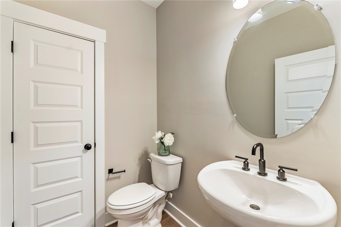 133 Osprey Landing Central, SC 29630 - Photo 11 of 34 This clean and bright bathroom features a pedestal sink and contemporary fixtures, enhancing its functional appeal.