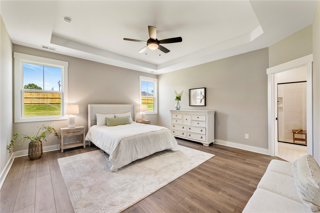 133 Osprey Landing Central, SC 29630 - Photo 12 of 34 This primary bedroom offers ample space, warm natural light, and direct access to a private bath.