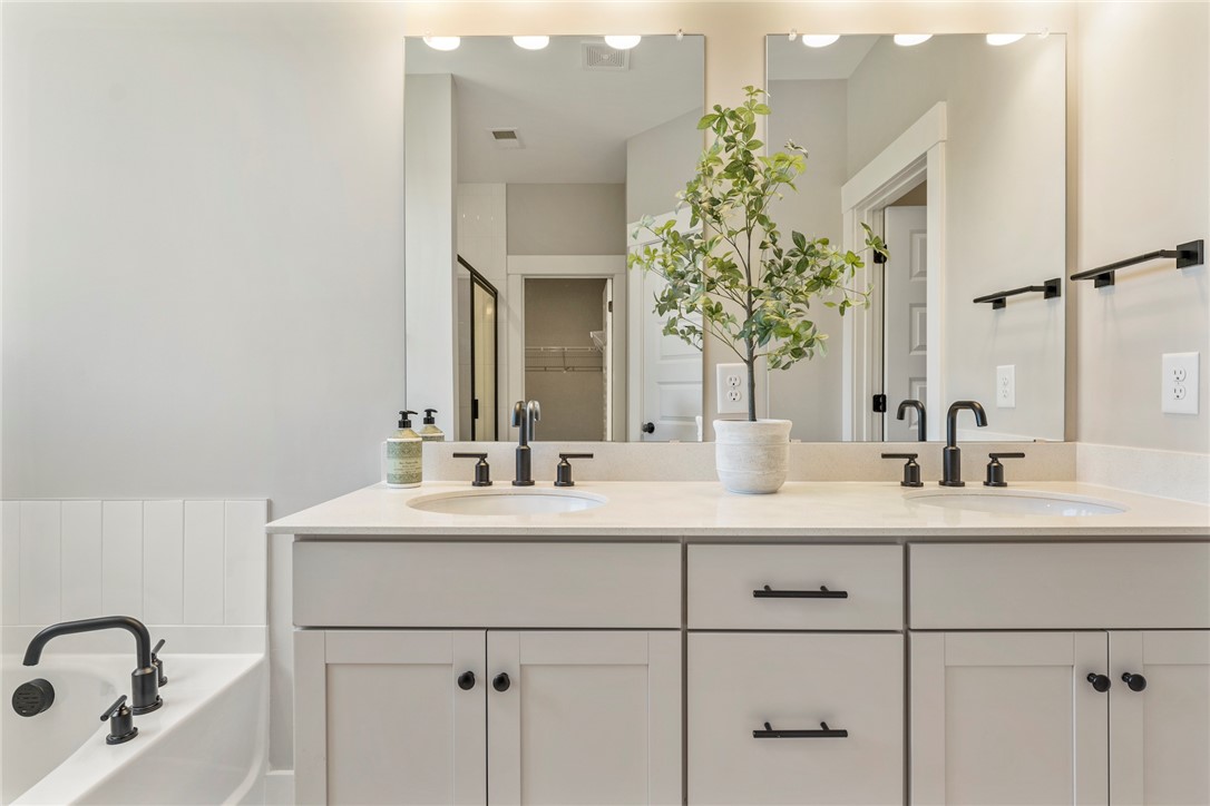 133 Osprey Landing Central, SC 29630 - Photo 14 of 34 This bathroom features a double vanity with ample storage and a soaking tub for relaxation.