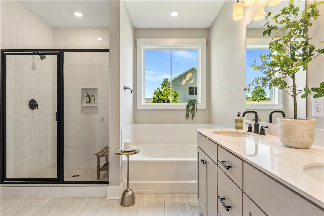 133 Osprey Landing Central, SC 29630 - Photo 15 of 34 This bright bathroom features a spacious shower, a soaking tub, and double vanity for optimal functionality.