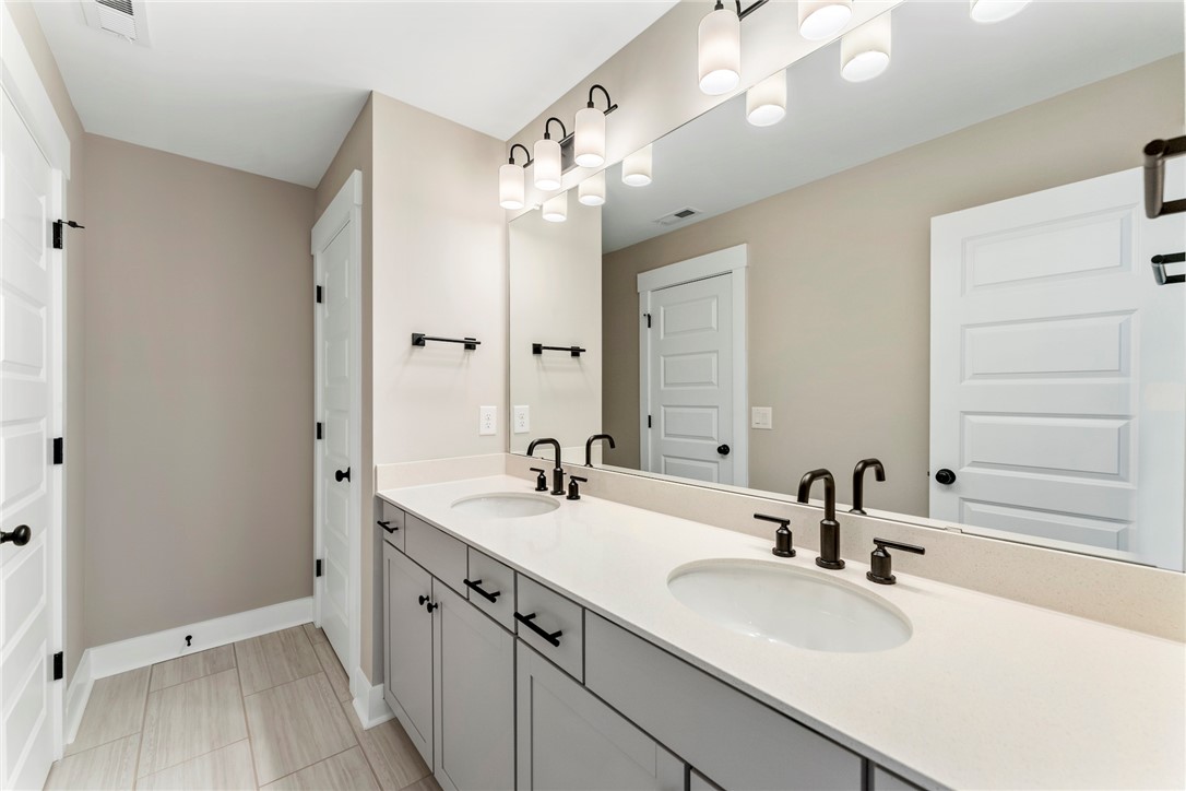 133 Osprey Landing Central, SC 29630 - Photo 19 of 34 This bathroom features a double vanity with ample counter space and sleek fixtures.