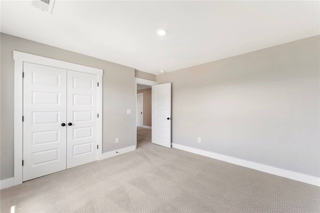 133 Osprey Landing Central, SC 29630 - Photo 22 of 34 This spacious room features neutral tones and plush carpeting, offering a comfortable and versatile living space.